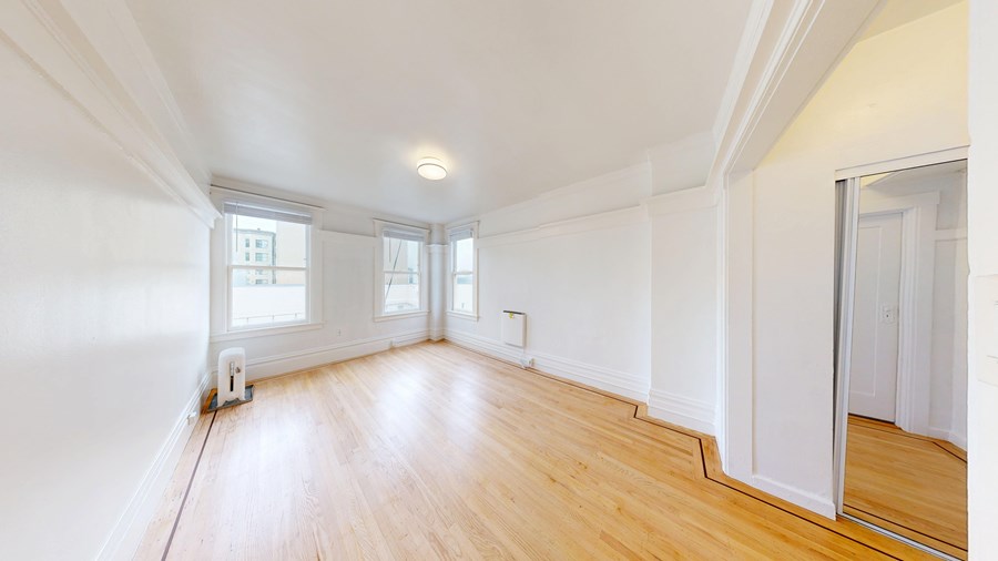 A room with wooden floors and white walls.